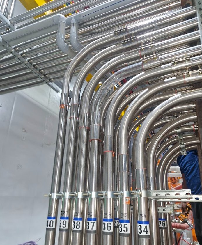 Numbered stainless conduit runs with precise bends