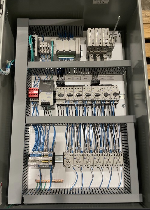 Tall automation control cabinet with organized blue cable runs